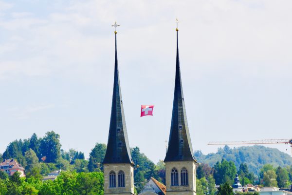 Schweizer Fahne zwischen den Türmen bei St. Leodigar, im Hof |© 2017 GFX
